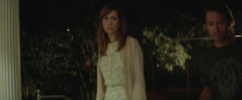 Movie still from “Hateship Loveship” (2013), directed by Liza Johnson – A woman standing in front of a tree at night; Medium shot, Over the shoulder angle