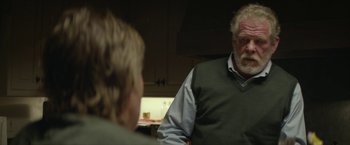 Movie still from “Hateship Loveship” (2013), directed by Liza Johnson – An older man talking to a younger man in a kitchen; Medium shot, Over the shoulder angle