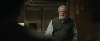 Movie still from “Hateship Loveship” (2013), directed by Liza Johnson – An older man standing in front of a mirror; Medium shot, Low angle