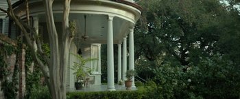 Movie still from “Hateship Loveship” (2013), directed by Liza Johnson – A porch that has a bench on the side of the porch; Extreme Wide shot, Low angle