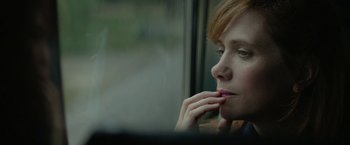 Movie still from “Hateship Loveship” (2013), directed by Liza Johnson – A person looking out of a train window; Close Up shot, High angle