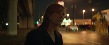 Movie still from “Hateship Loveship” (2013), directed by Liza Johnson – A woman standing on the side of a road at night; Close Up shot, Over the shoulder angle