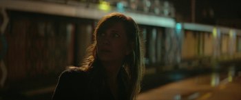 Movie still from “Hateship Loveship” (2013), directed by Liza Johnson – A woman with long brown hair looking up at the sky; Close Up shot, Over the shoulder angle