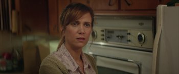 Movie still from “Hateship Loveship” (2013), directed by Liza Johnson – A person in a room with a stove; Close Up shot, Over the shoulder angle