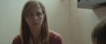 Movie still from “Hateship Loveship” (2013), directed by Liza Johnson – A person with long blonde hair; Close Up shot, Over the shoulder angle