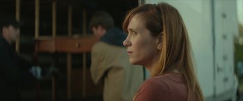 Movie still from “Hateship Loveship” (2013), directed by Liza Johnson – A person looking at something; Close Up shot, Over the shoulder angle