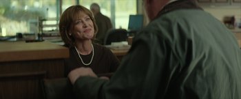 Movie still from “Hateship Loveship” (2013), directed by Liza Johnson – A woman sitting at a table talking to a man; Medium shot, Over the shoulder angle