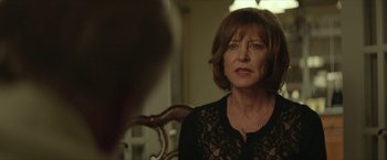 Movie still from “Hateship Loveship” (2013), directed by Liza Johnson – A woman sitting in front of a mirror in a room; Close Up shot, Over the shoulder angle