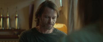 Movie still from “Hateship Loveship” (2013), directed by Liza Johnson – A person with long brown hair; Close Up shot, Over the shoulder angle