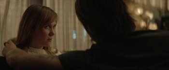 Movie still from “Hateship Loveship” (2013), directed by Liza Johnson – Two people sitting in front of each other in front of a window; Close Up shot, Over the shoulder angle