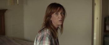 Movie still from “Hateship Loveship” (2013), directed by Liza Johnson – A person wearing a plaid shirt; Close Up shot, Over the shoulder angle