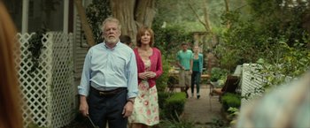 Movie still from “Hateship Loveship” (2013), directed by Liza Johnson – A group of people standing in a garden; Wide shot, Over the shoulder angle