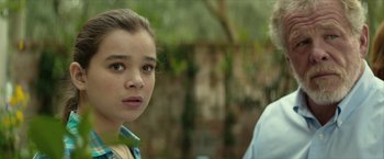 Movie still from “Hateship Loveship” (2013), directed by Liza Johnson – A young girl and an older man standing next to each other in front of a tree; Close Up shot, Over the shoulder angle