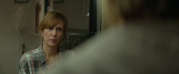 Movie still from “Hateship Loveship” (2013), directed by Liza Johnson – A woman sitting in front of a bathroom mirror; Close Up shot, Over the shoulder angle