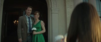 Movie still from “Hateship Loveship” (2013), directed by Liza Johnson – A man and a woman posing for a picture; Medium shot, Over the shoulder angle