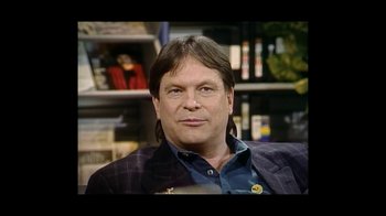 Movie still from “He Dreams of Giants” (2019), directed by Louis Pepe – A person sitting in a chair; Close Up shot, Over the shoulder angle