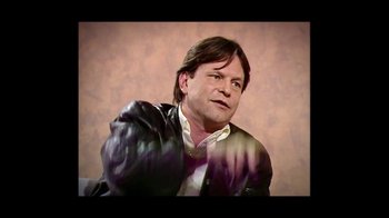 Movie still from “He Dreams of Giants” (2019), directed by Louis Pepe – A man with long hair and a white shirt is wearing a leather jacket; Close Up shot, Low angle