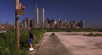 Movie still from “He Got Game” (1998), directed by Spike Lee – A man is playing basketball in the middle of the city; Extreme Wide shot, Low angle