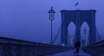 Movie still from “He Got Game” (1998), directed by Spike Lee – Two people walking across a bridge in the rain; Extreme Wide shot, Low angle