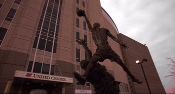 Movie still from “He Got Game” (1998), directed by Spike Lee – A statue of a basketball player jumping in the air; Extreme Wide shot, Low angle