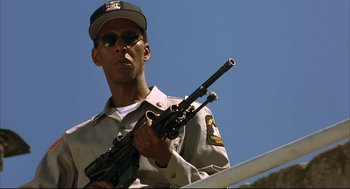 Movie still from “He Got Game” (1998), directed by Spike Lee – A man holding a rifle in his hands; Close Up shot, Low angle