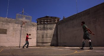 Movie still from “He Got Game” (1998), directed by Spike Lee – A man is playing basketball on the street; Extreme Wide shot, Low angle