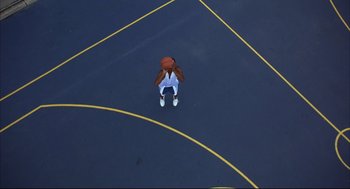 Movie still from “He Got Game” (1998), directed by Spike Lee – An overhead view of a person in a basketball uniform; Extreme Wide shot, Overhead angle