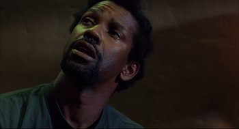 Movie still from “He Got Game” (1998), directed by Spike Lee – A person with a beard looking up; Close Up shot, Low angle