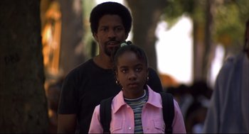 Movie still from “He Got Game” (1998), directed by Spike Lee – A man standing next to a young girl in front of a tree; Close Up shot, Low angle