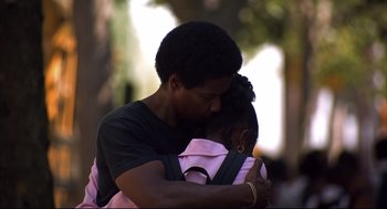 Movie still from “He Got Game” (1998), directed by Spike Lee – A man and a woman hugging each other outside; Close Up shot, Low angle