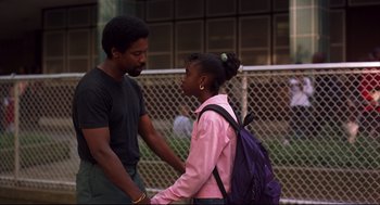Movie still from “He Got Game” (1998), directed by Spike Lee – A man and a woman standing next to each other; Medium shot, Over the shoulder angle