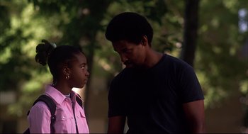Movie still from “He Got Game” (1998), directed by Spike Lee – A man and a girl standing next to each other in a park; Close Up shot, Over the shoulder angle