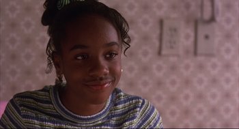 Movie still from “He Got Game” (1998), directed by Spike Lee – A young girl is smiling for the camera; Close Up shot, High angle