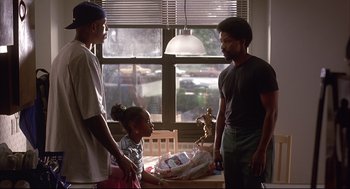 Movie still from “He Got Game” (1998), directed by Spike Lee – Two men and a little girl standing in front of a window; Medium shot, Over the shoulder angle
