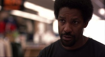 Movie still from “He Got Game” (1998), directed by Spike Lee – A person wearing a black t - shirt; Close Up shot, Over the shoulder angle