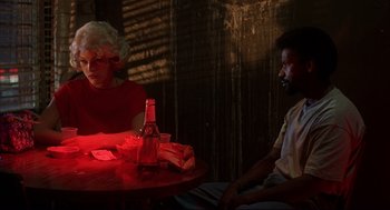 Movie still from “He Got Game” (1998), directed by Spike Lee – A man and a woman sitting at a table with drinks; Medium shot, Over the shoulder angle