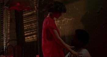 Movie still from “He Got Game” (1998), directed by Spike Lee – A woman in a red dress standing next to a man in a red shirt; Medium shot, Over the shoulder angle