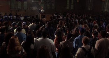 Movie still from “He Got Game” (1998), directed by Spike Lee – A crowd of people gathered in front of a man speaking; Extreme Wide shot, High angle