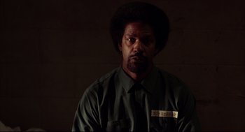 Movie still from “He Got Game” (1998), directed by Spike Lee – A man in a green shirt is looking at the camera; Close Up shot, Over the shoulder angle