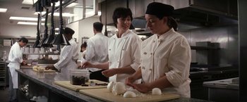 Movie still from “He's Just Not That Into You” (2009), directed by Ken Kwapis – A group of women working in a restaurant kitchen; Medium shot, Low angle