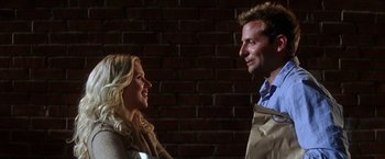 Movie still from “He's Just Not That Into You” (2009), directed by Ken Kwapis – A man and a woman smiling at each other in front of a brick wall; Medium shot, Over the shoulder angle