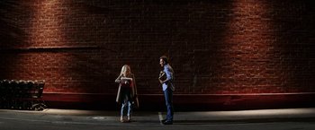 Movie still from “He's Just Not That Into You” (2009), directed by Ken Kwapis – A man and a woman standing next to each other on the side of the street; Wide shot, Over the shoulder angle