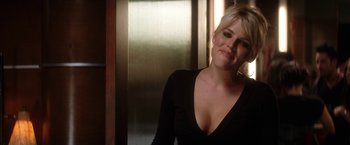 Movie still from “He's Just Not That Into You” (2009), directed by Ken Kwapis – A woman in a black shirt smiling for the camera; Close Up shot, Over the shoulder angle