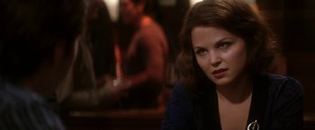 Movie still from “He's Just Not That Into You” (2009), directed by Ken Kwapis – A person sitting at a table; Close Up shot, Over the shoulder angle