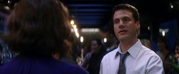 Movie still from “He's Just Not That Into You” (2009), directed by Ken Kwapis – A man in a white dress shirt and a woman in a black tie; Close Up shot, Over the shoulder angle