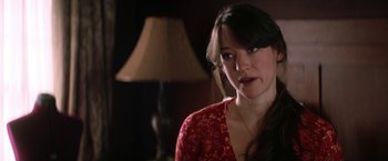Movie still from “He's Just Not That Into You” (2009), directed by Ken Kwapis – A woman in a red dress sitting in front of a lamp; Close Up shot, Over the shoulder angle