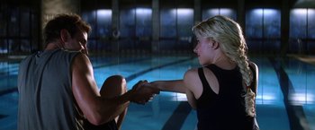 Movie still from “He's Just Not That Into You” (2009), directed by Ken Kwapis – A man and a woman shaking hands in front of a swimming pool; Medium shot, Over the shoulder angle