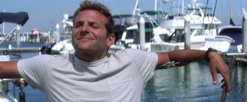 Movie still from “He's Just Not That Into You” (2009), directed by Ken Kwapis – A man with his arms outstretched in front of boats; Close Up shot, Low angle