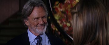Movie still from “He's Just Not That Into You” (2009), directed by Ken Kwapis – An older man in a suit and tie with an umbrella; Close Up shot, Over the shoulder angle