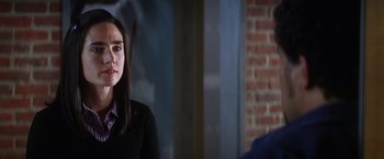 Movie still from “He's Just Not That Into You” (2009), directed by Ken Kwapis – A woman sitting in front of a brick wall in a room; Close Up shot, Over the shoulder angle